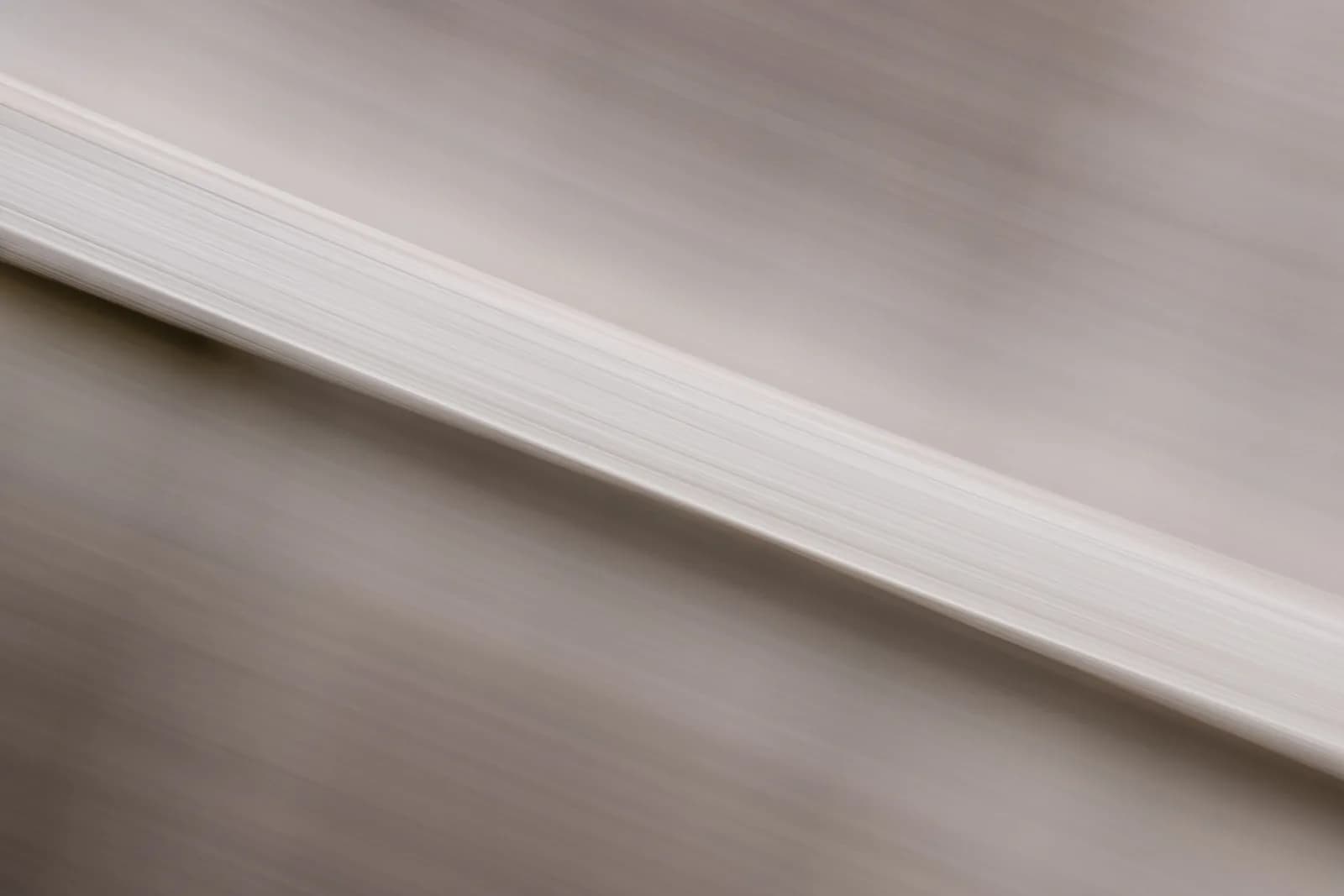 Abstract image featuring blurred motion with a white textured pattern.