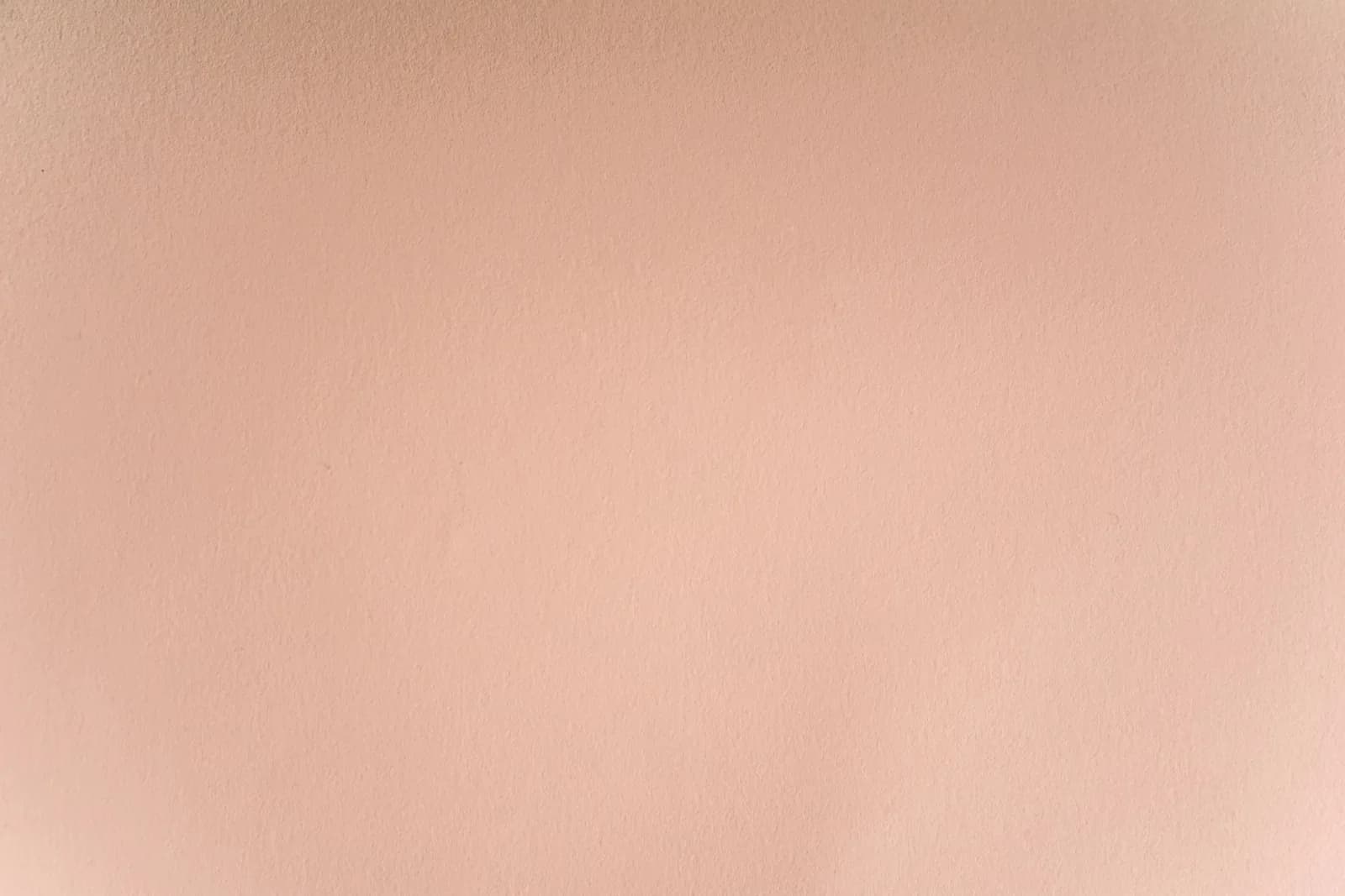 A seamless and smooth pastel pink wall texture perfect for backgrounds and design projects.