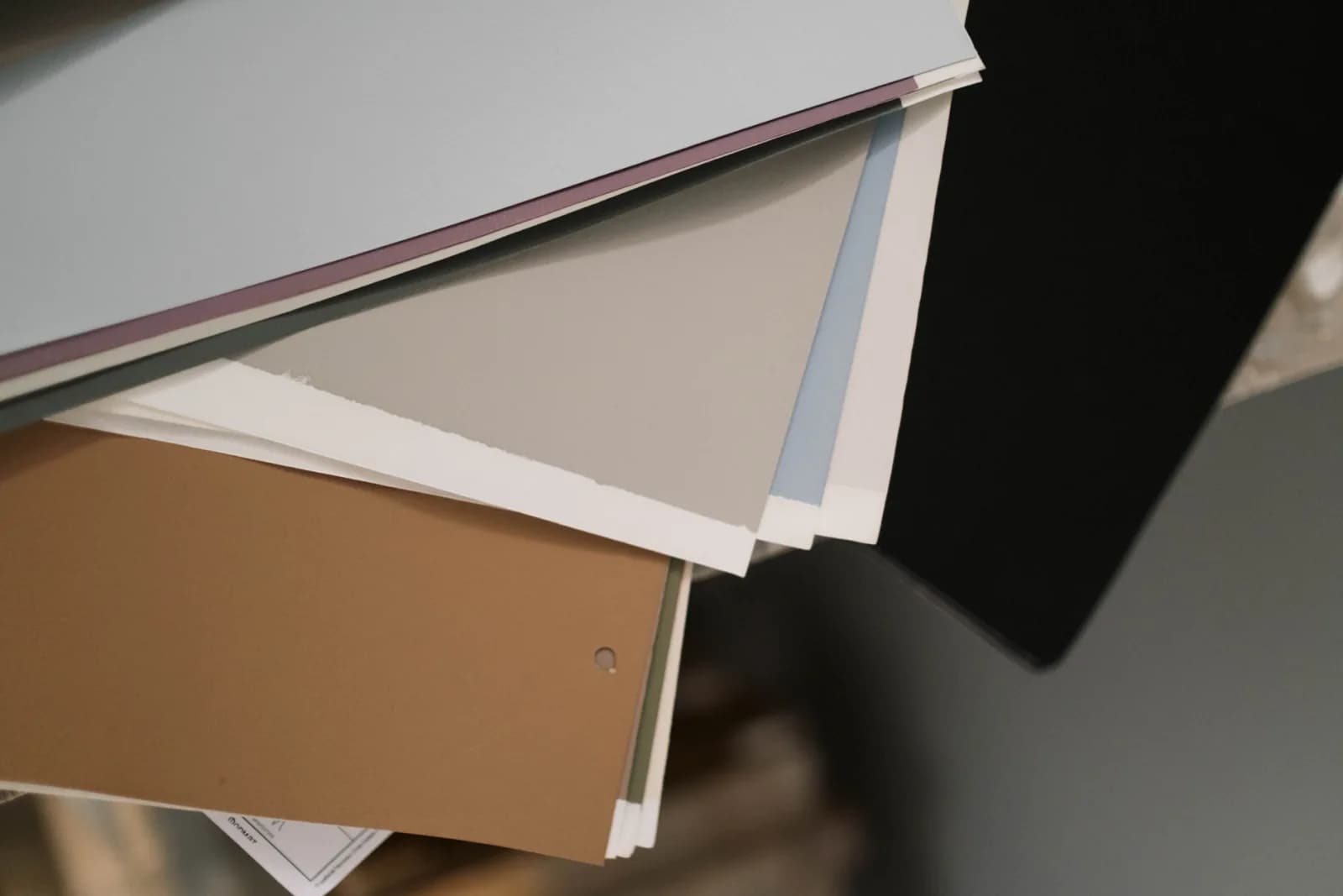 A close-up of assorted colored paper sheets, ideal for design and stationery projects.