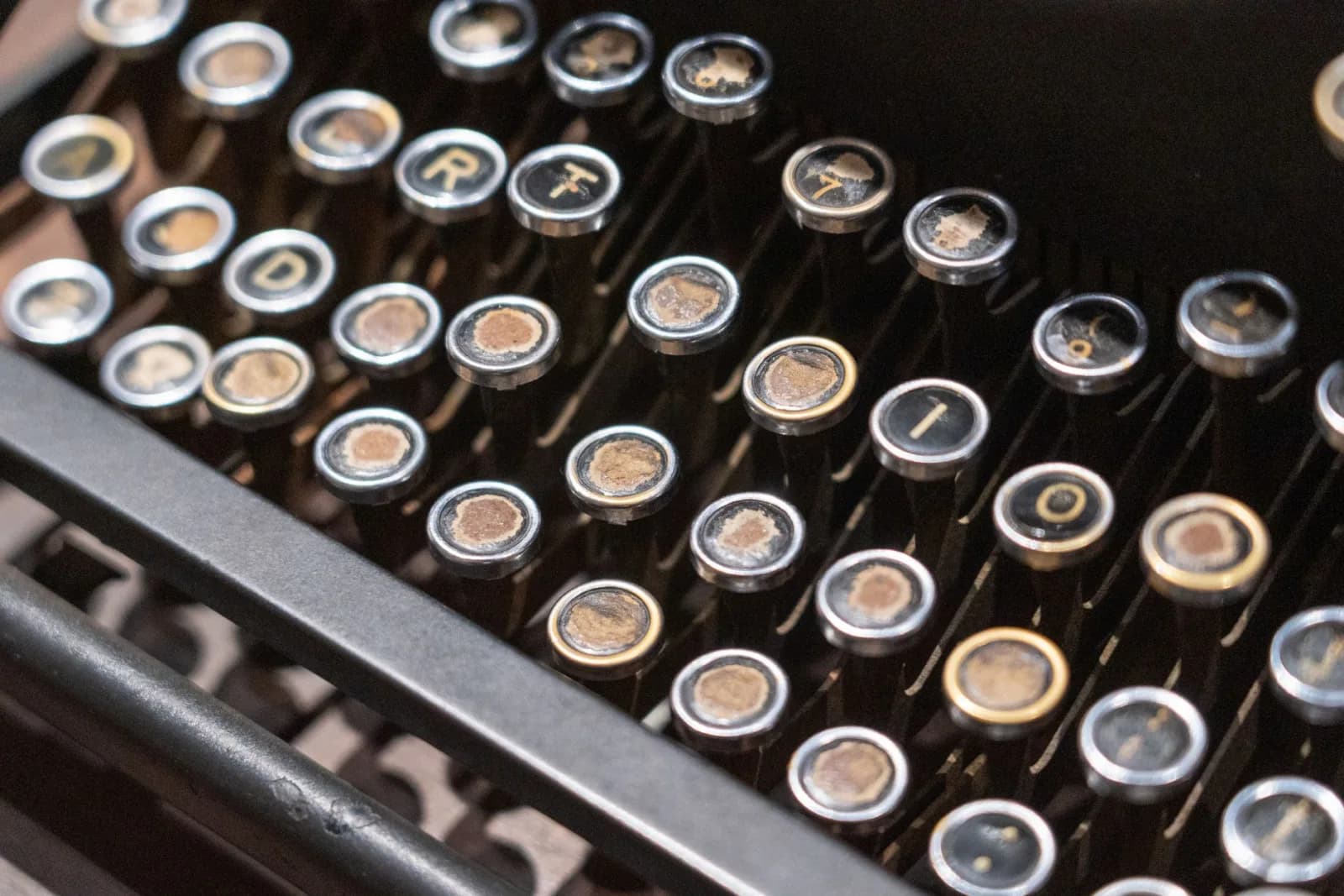 Detailed view of antique typewriter keyboard showing aged keys.