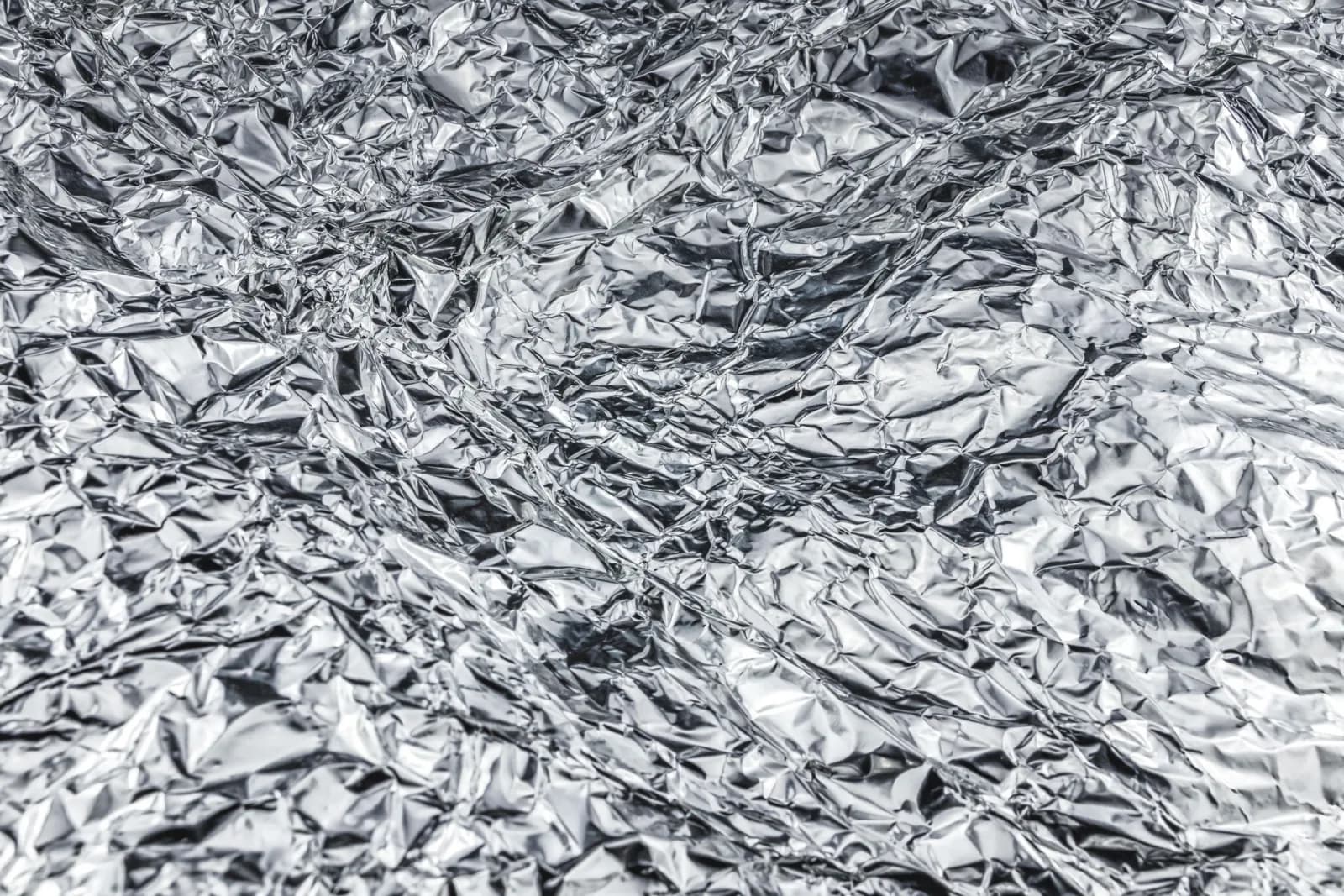 Close-up of crumpled aluminum foil creating a shiny, textured surface.