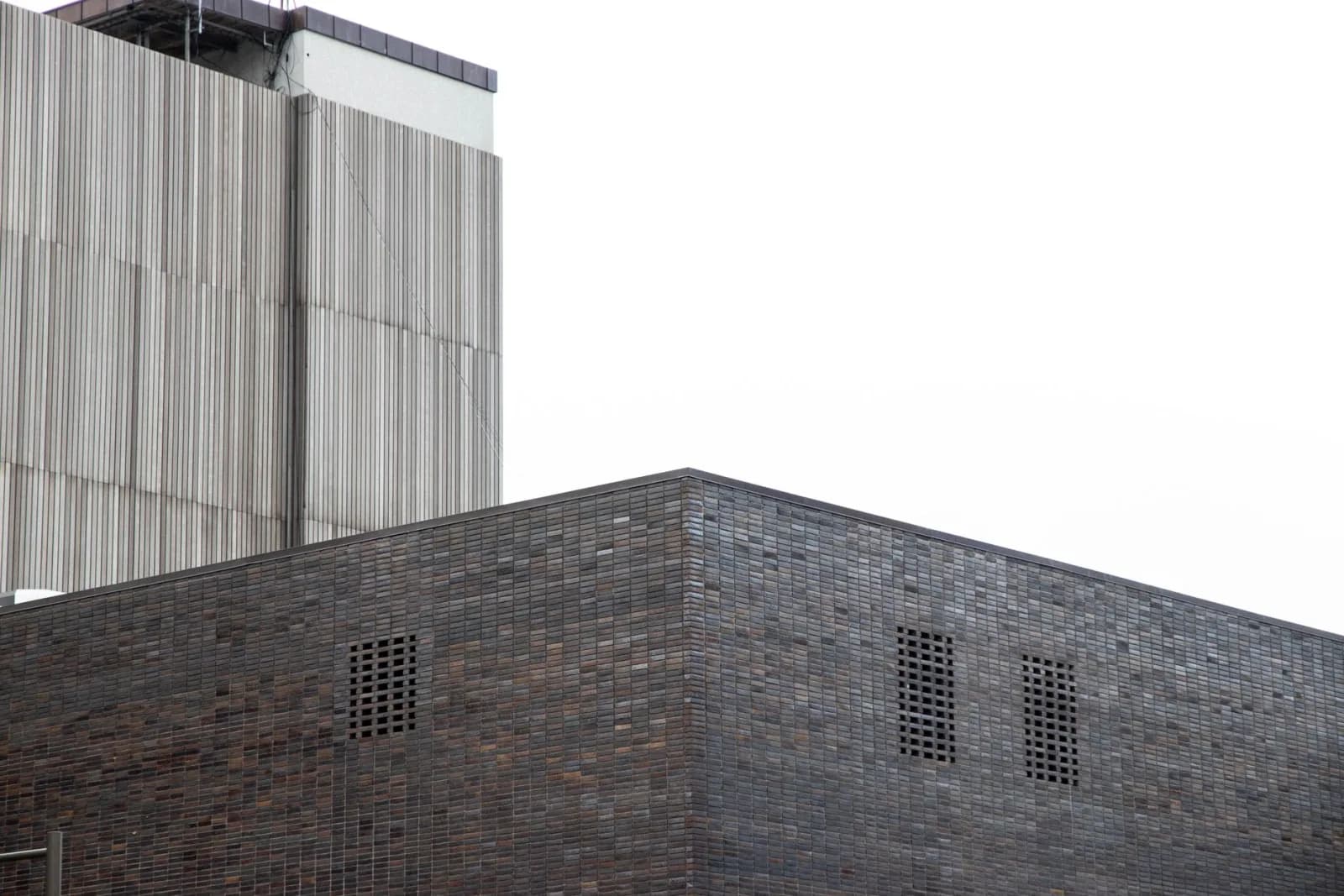 Abstract view of modern minimalist architecture featuring brick and concrete textures.