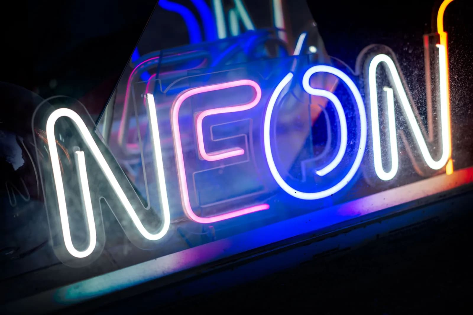 A close-up view of a vibrant neon sign showcasing bright colors and luminescence.