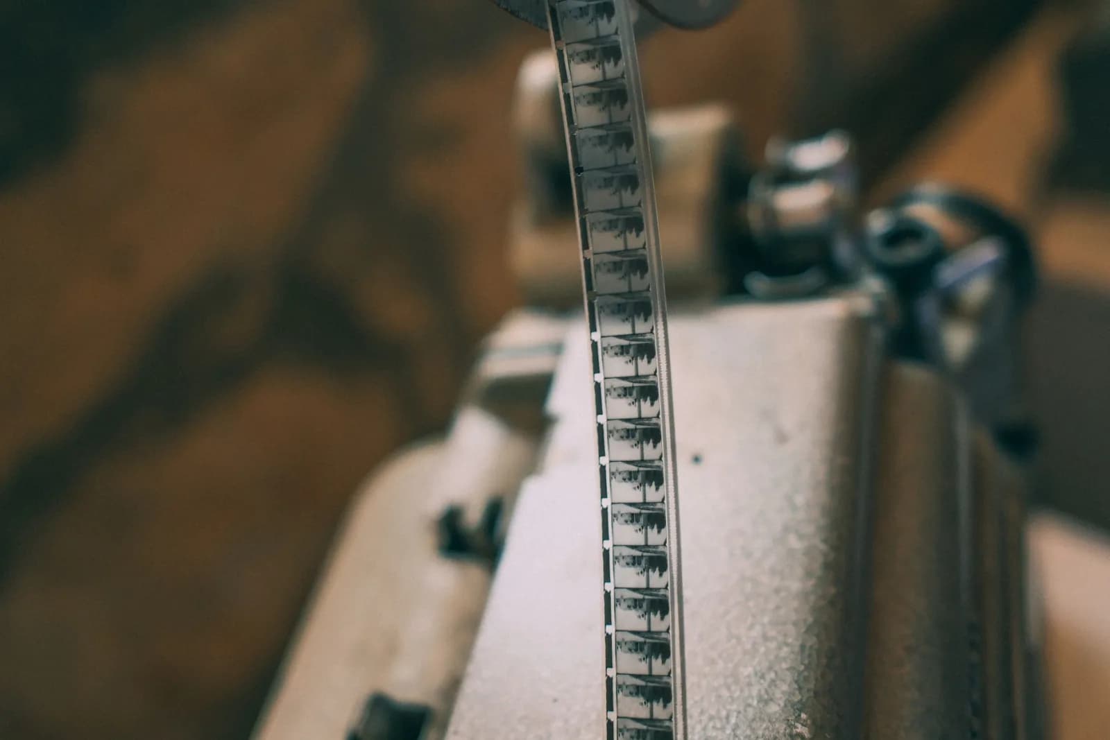 Close-up of a vintage film strip on a projector, showcasing classic cinema.
