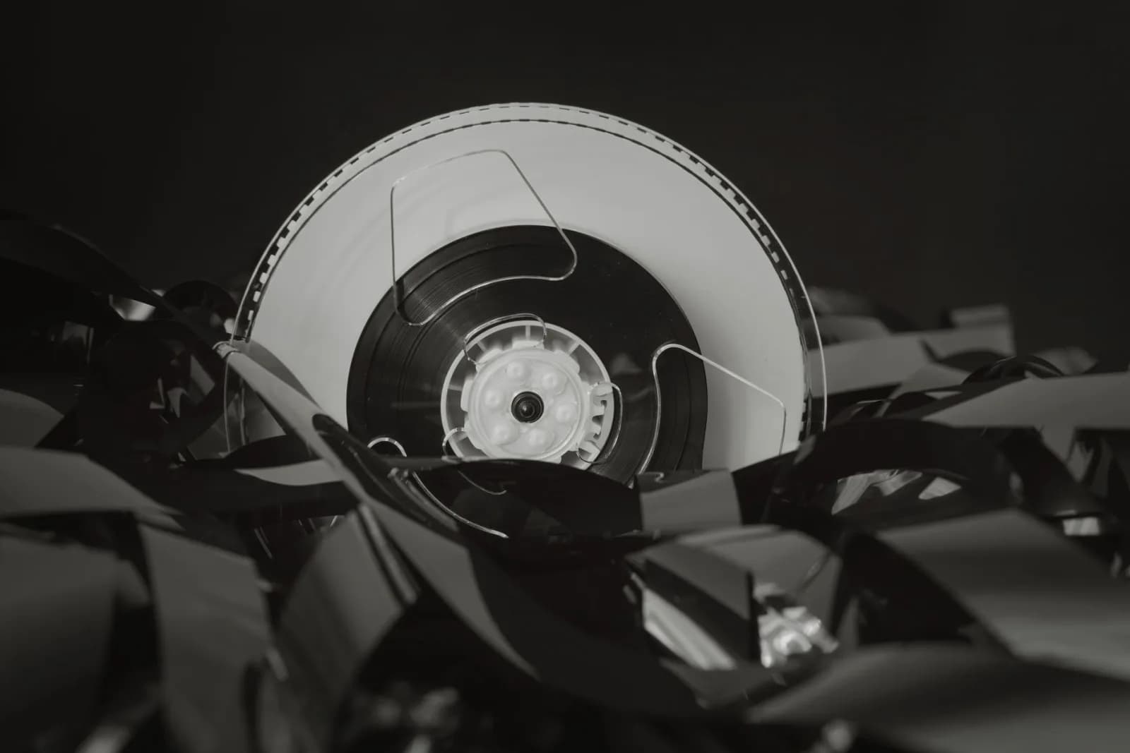 Close-up of a vintage cassette tape against a black background, showcasing retro technology.