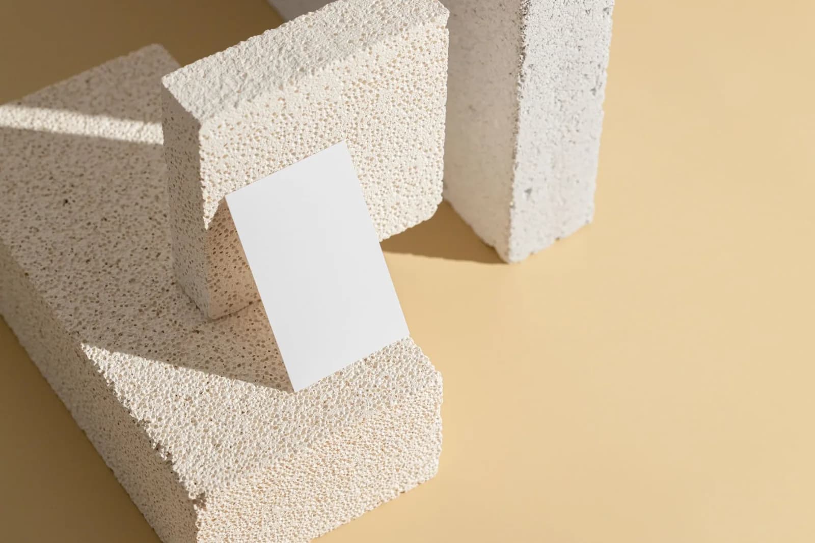 Modern minimalist design featuring textured blocks and blank paper, perfect for creative backgrounds.
