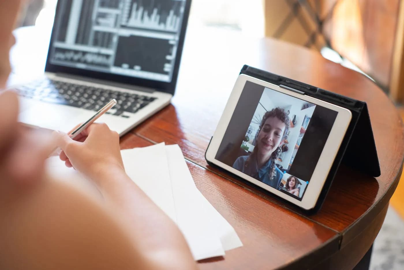 A business owner on a video call from her desk