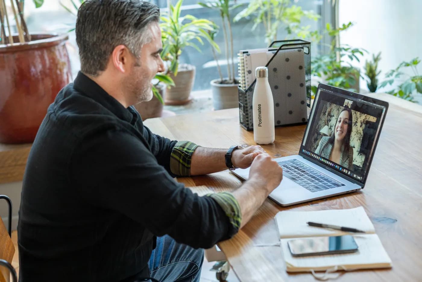 A business owner on a video call at his desk
