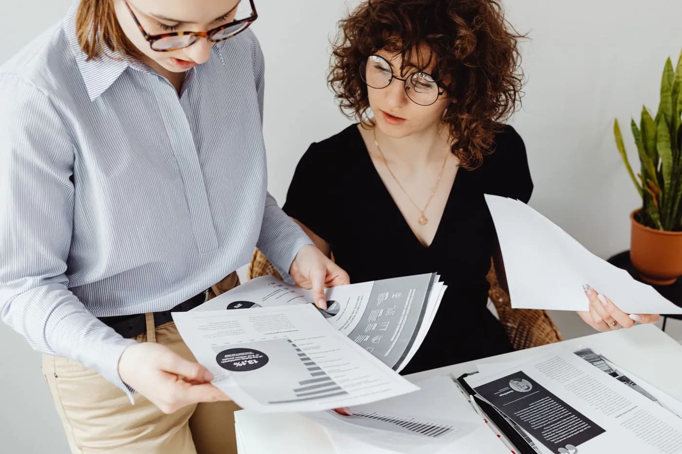 Two colleagues reviewing a printed report together