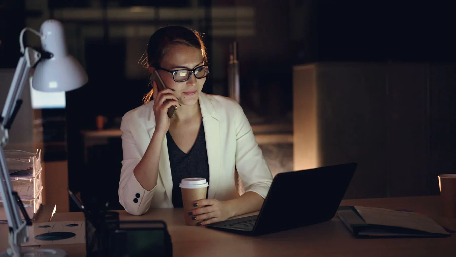 A founder working late at a laptop with a coffee, planning a new product
