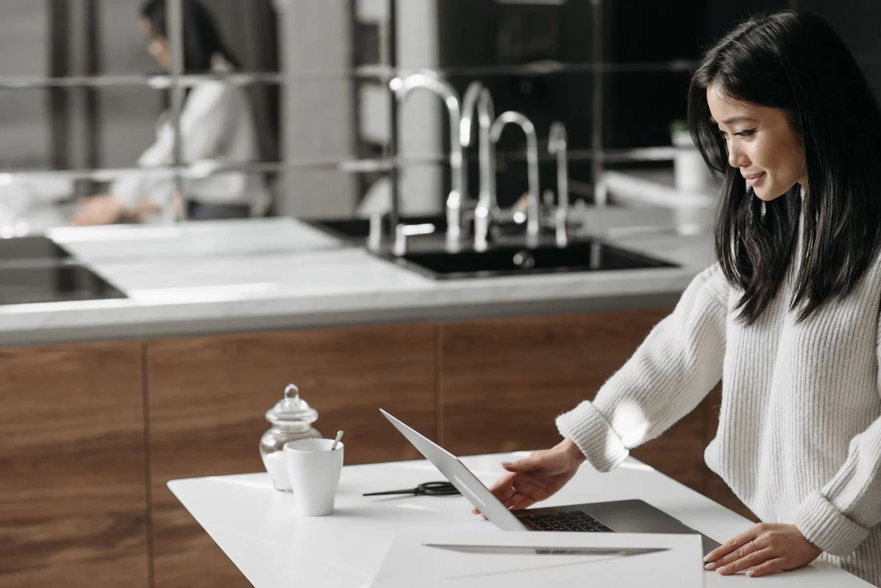 A business owner reviewing the company website on a laptop at home