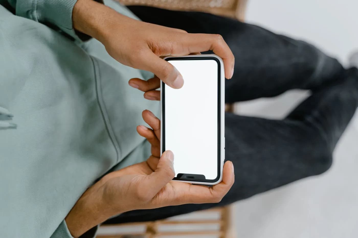 Hands testing an app on a smartphone
