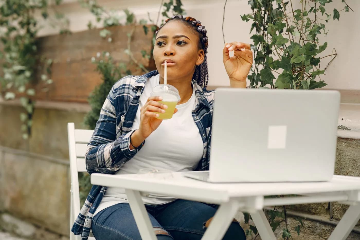 A freelancer working on her laptop at a café table