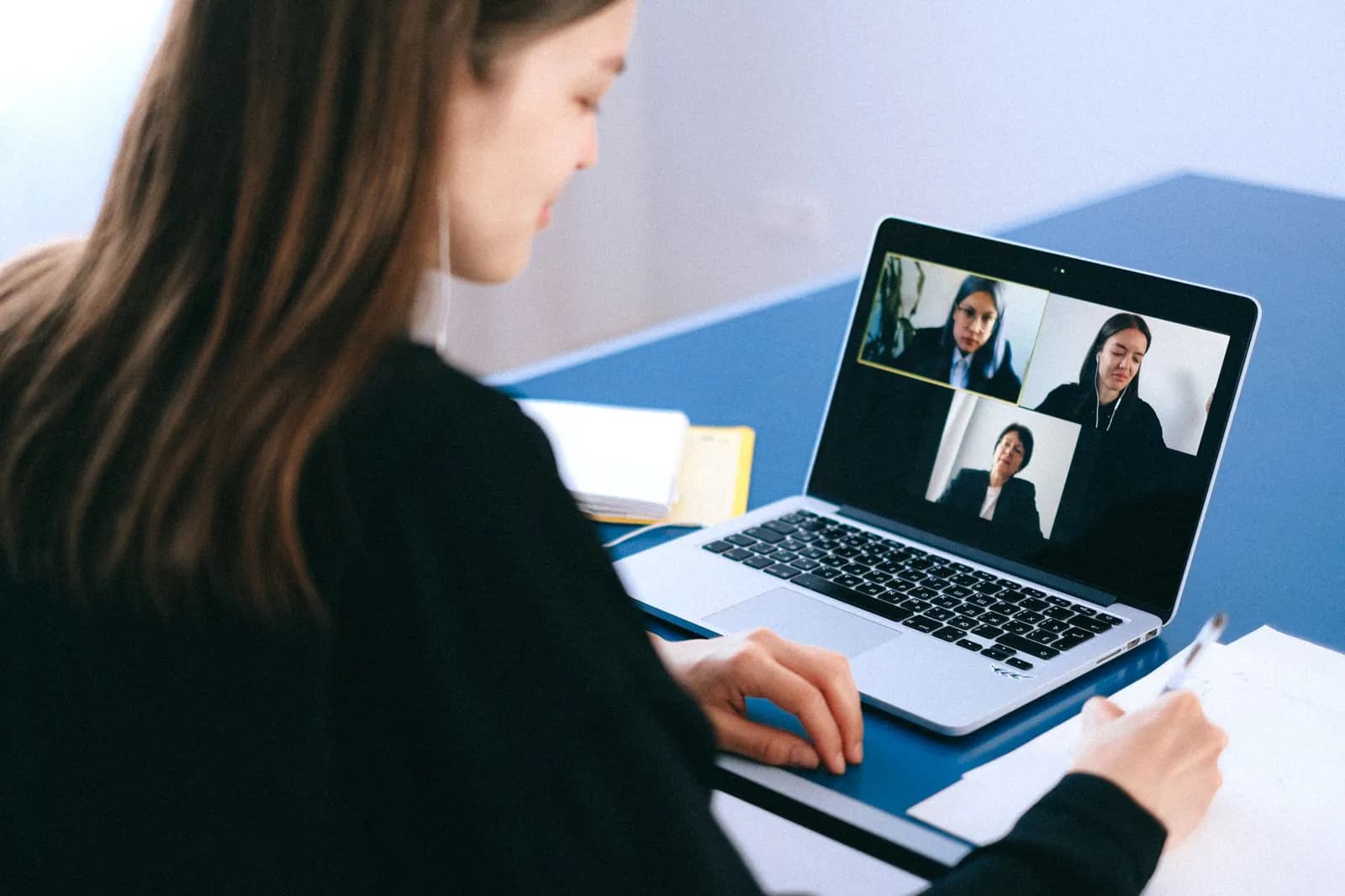 A businesswoman on a video call at her laptop