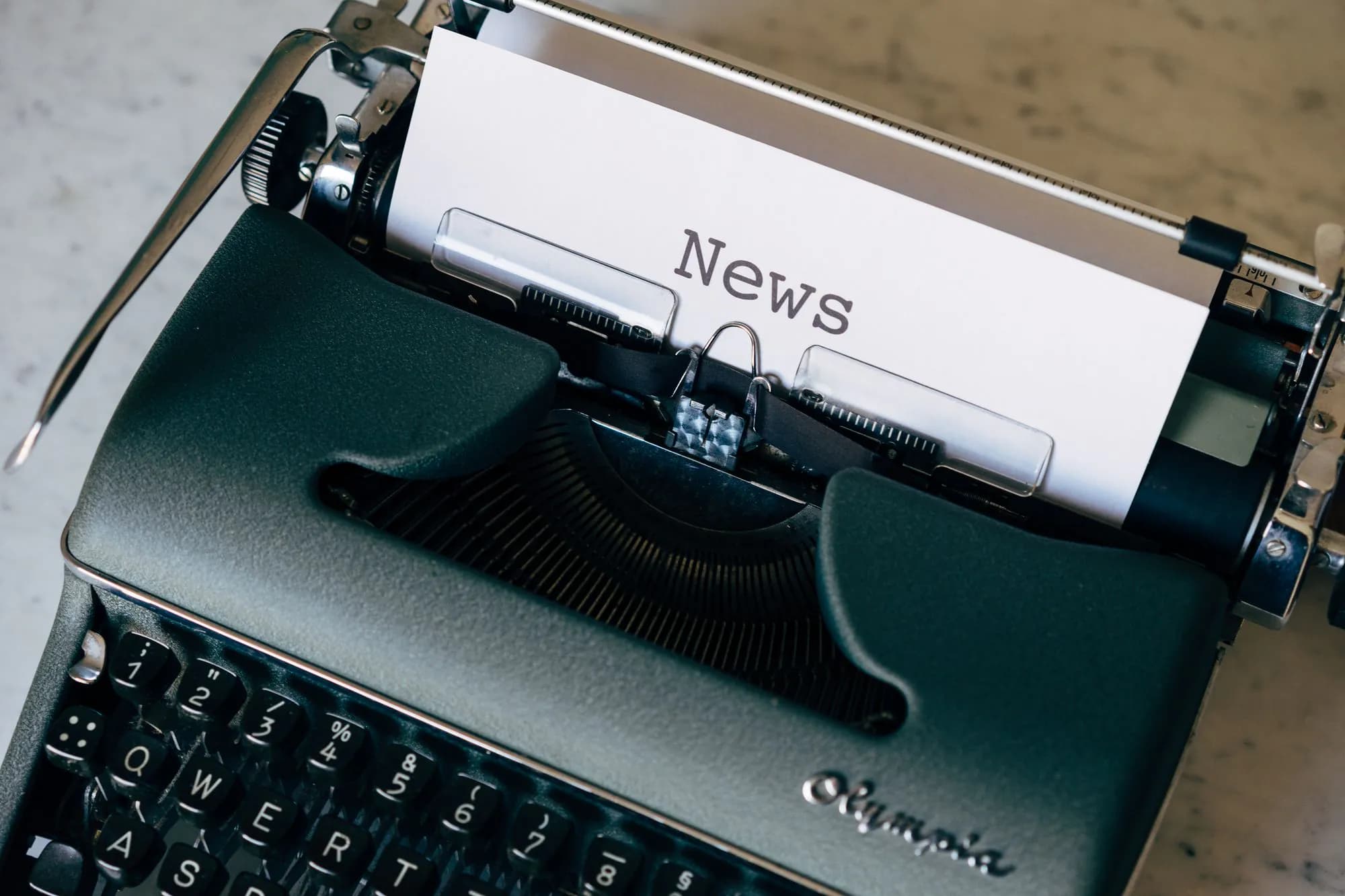 A typewriter with a sheet of paper headed News