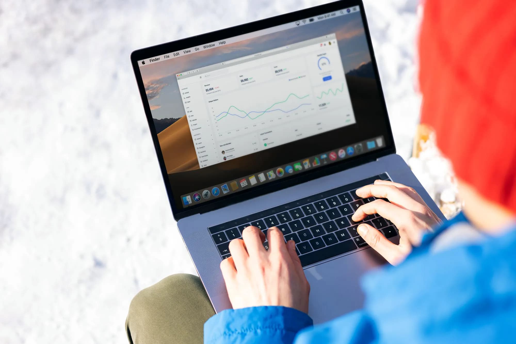 A person checking analytics on a laptop outdoors