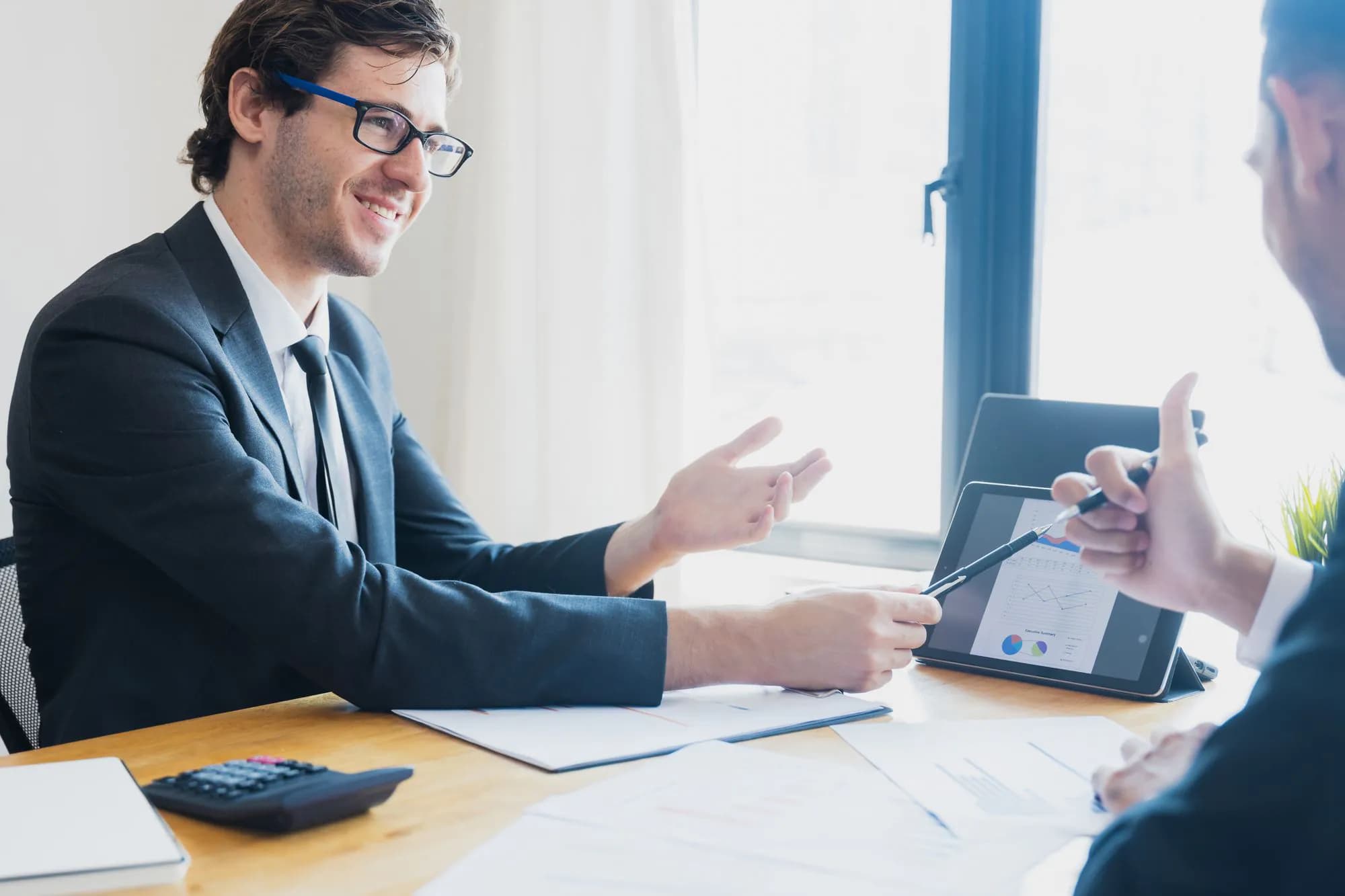 A consultant walking a business owner through a report