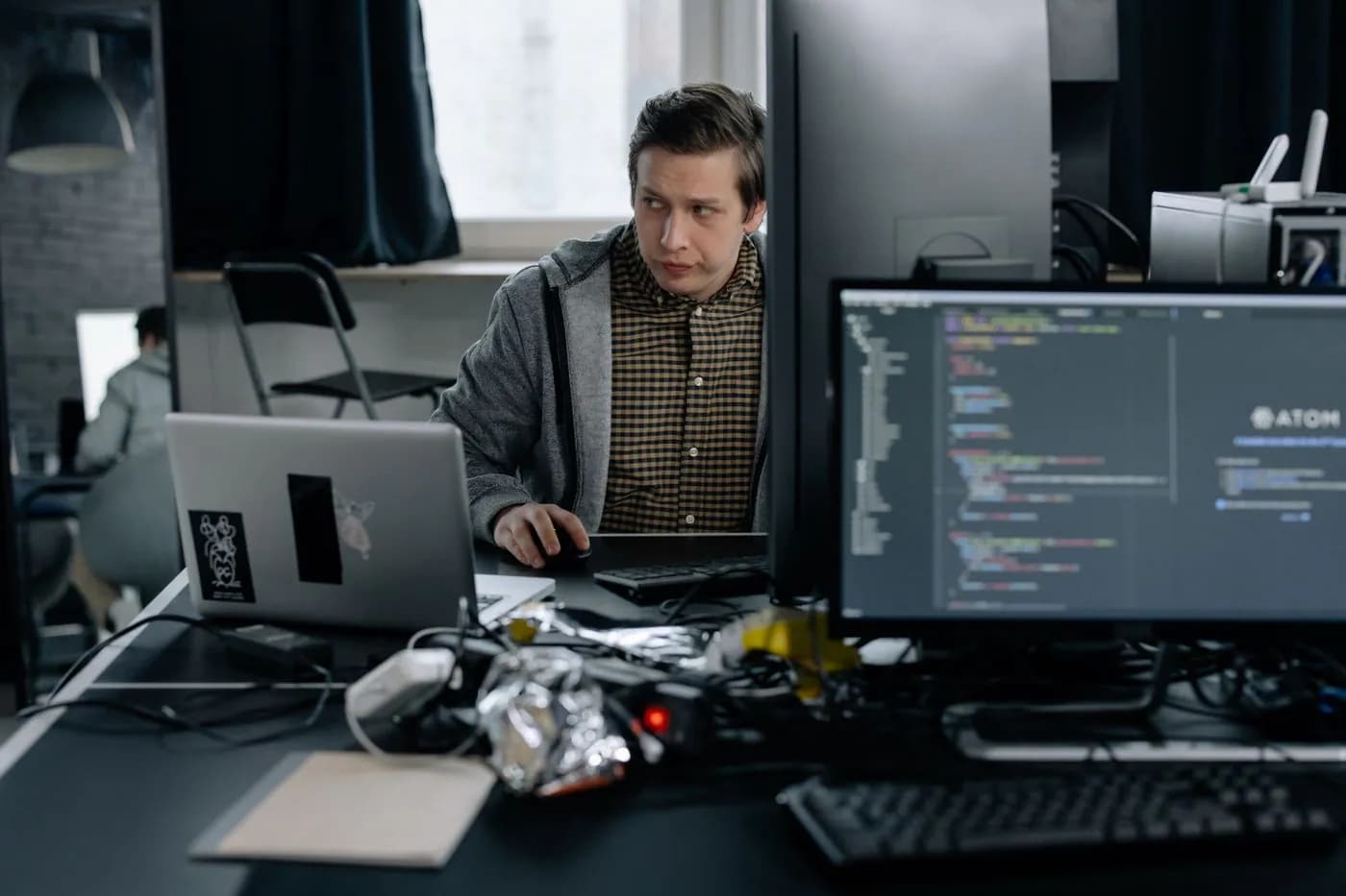 A programmer reading through unfamiliar code at his desk