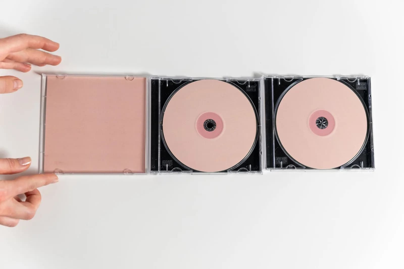 A minimalistic flat lay of CDs designed to resemble abstract feminist art using optical discs.