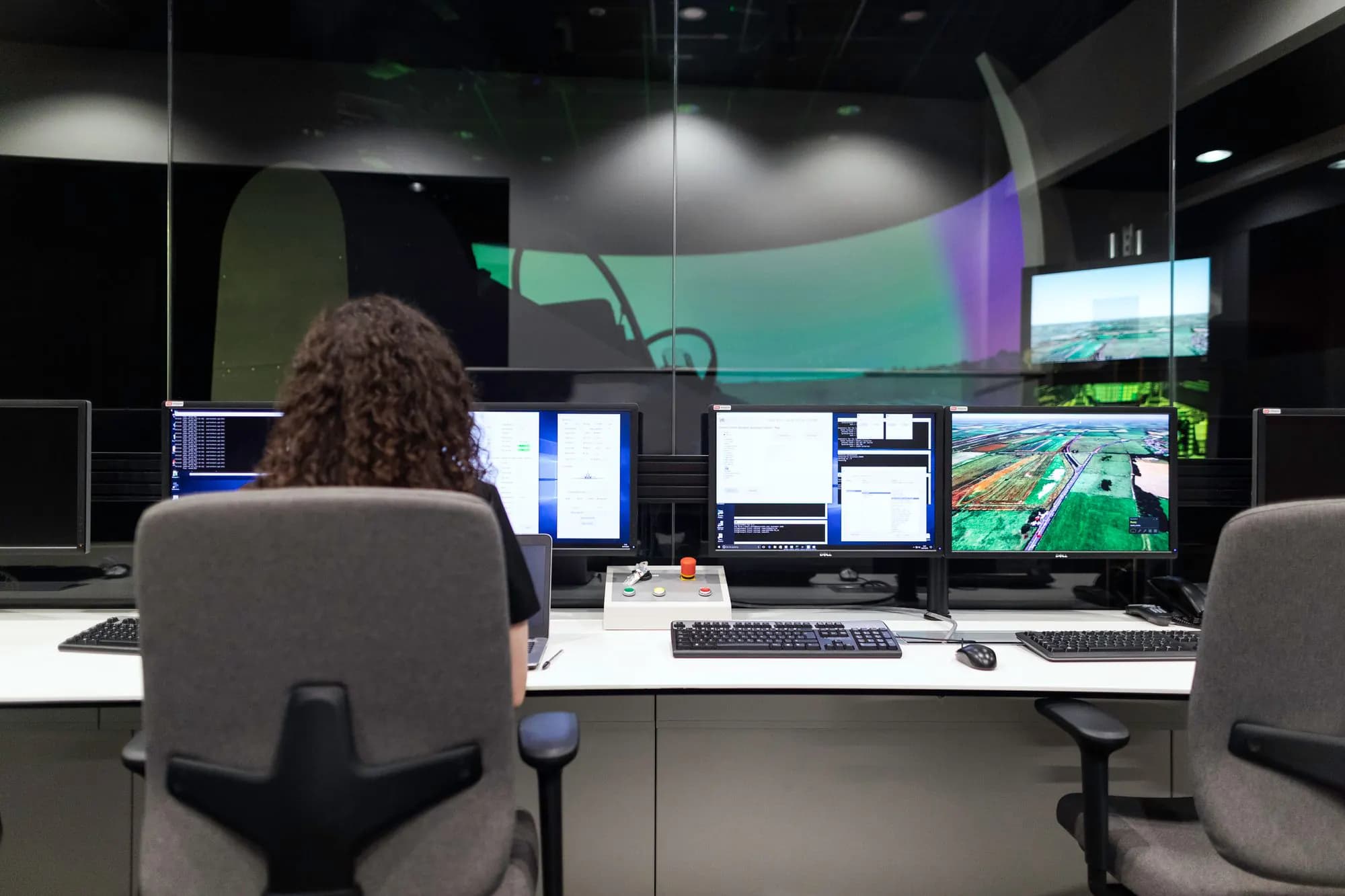 An engineer watching several monitoring screens.