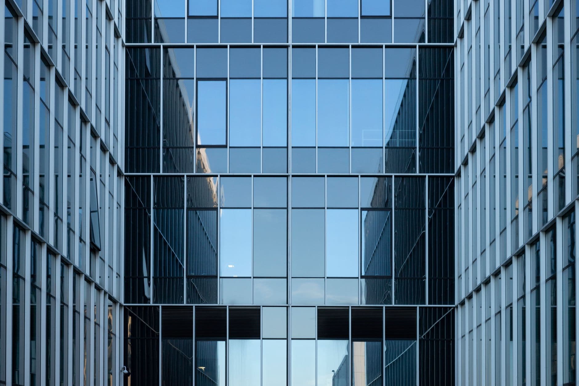 A contemporary office facade with reflective glass windows.