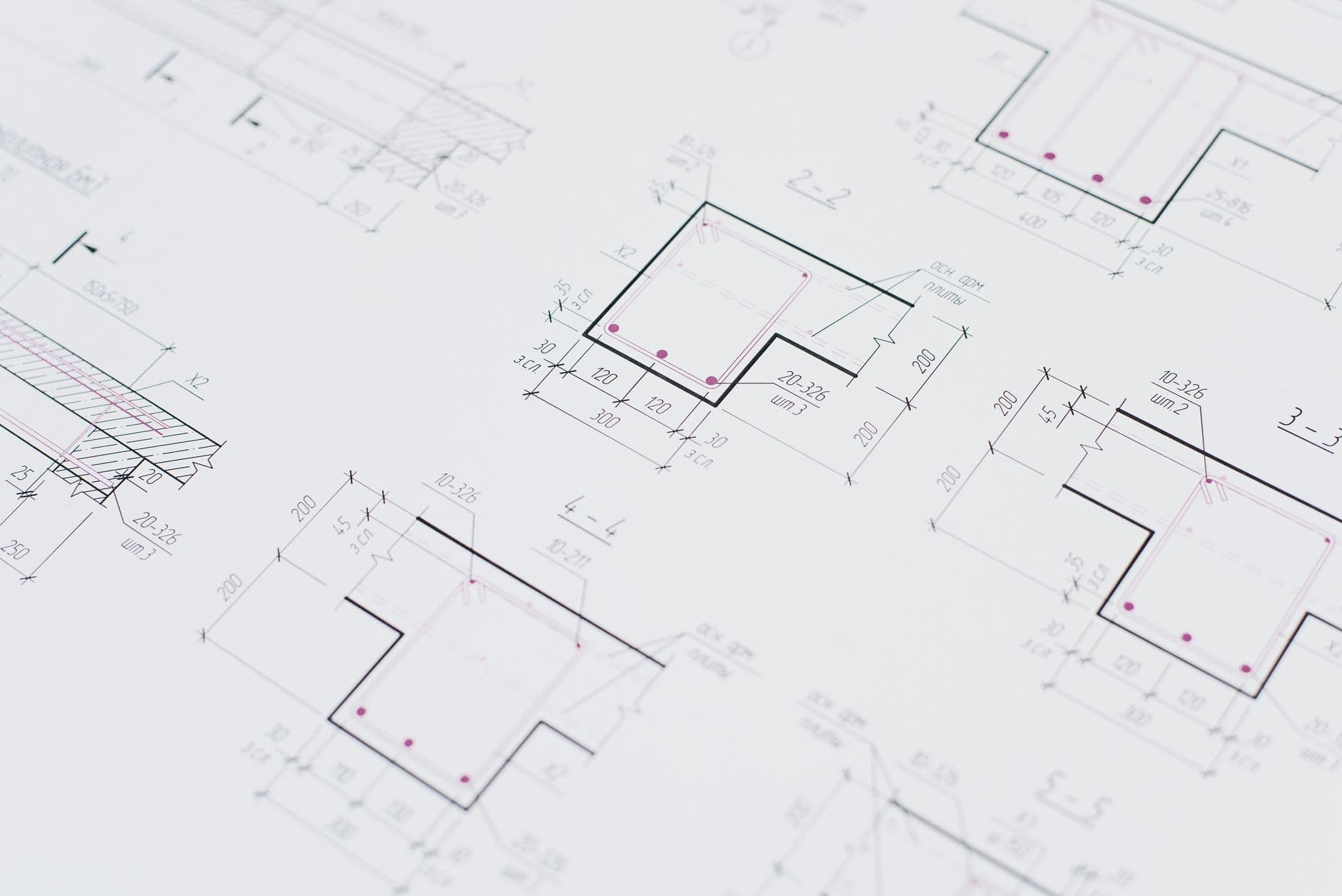 Technical product plans spread on a work surface.