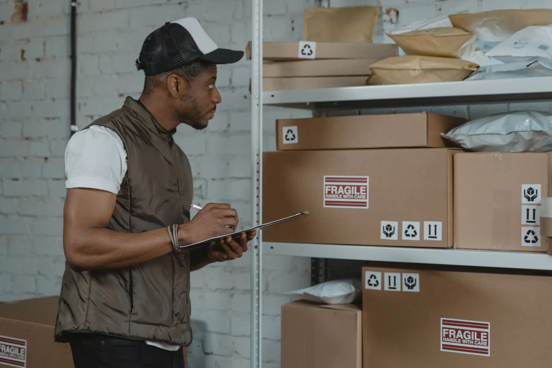 A warehouse courier checking parcels before they leave