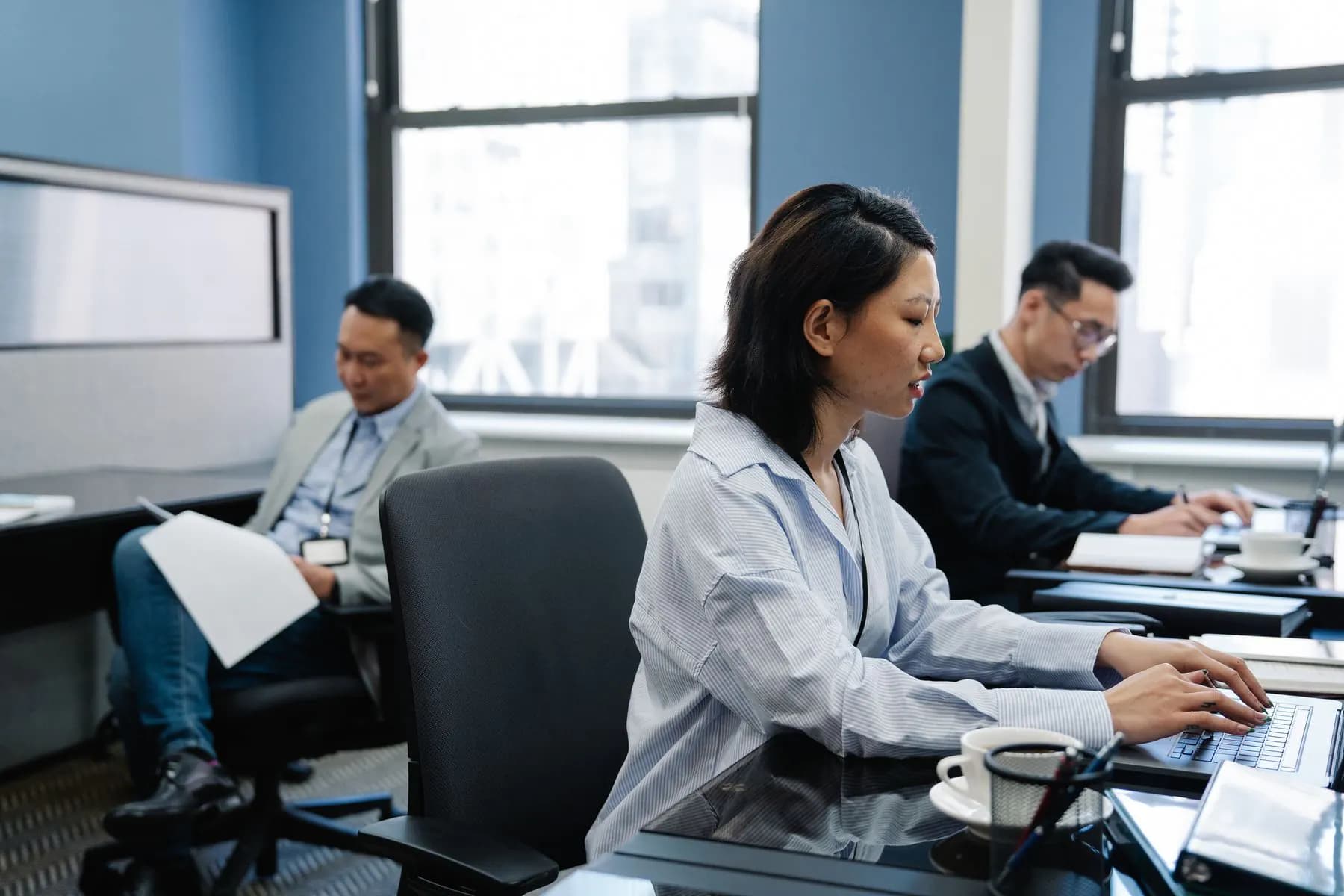 An office team working in their company's own software on laptops