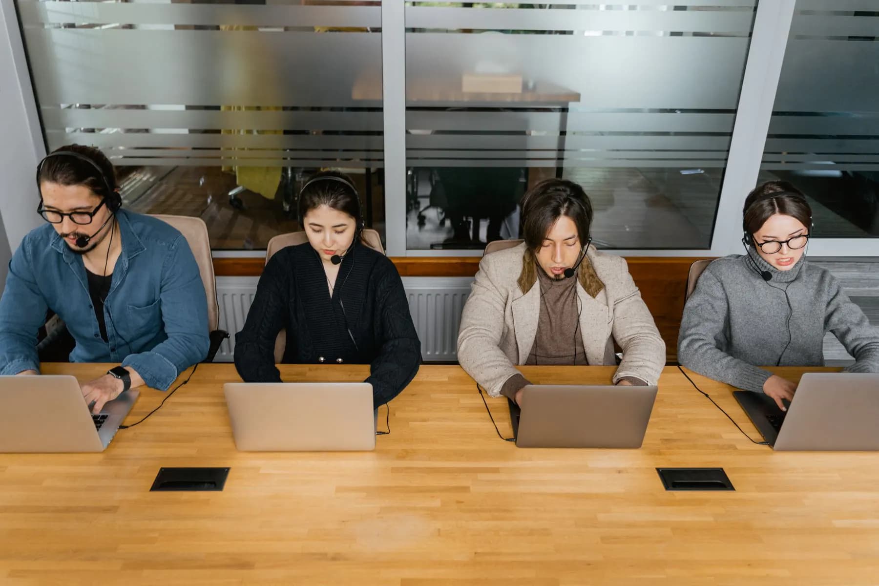 A customer support team on headsets, working in their subscription software