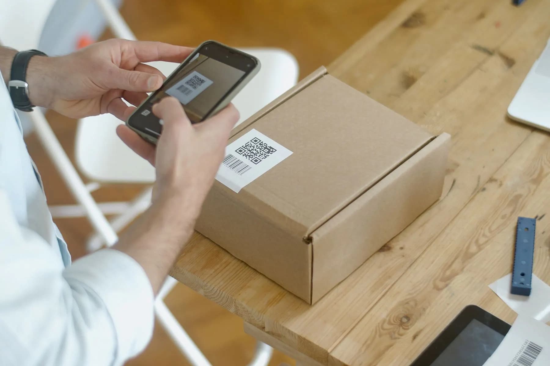A parcel being scanned with a phone as the order leaves the shop