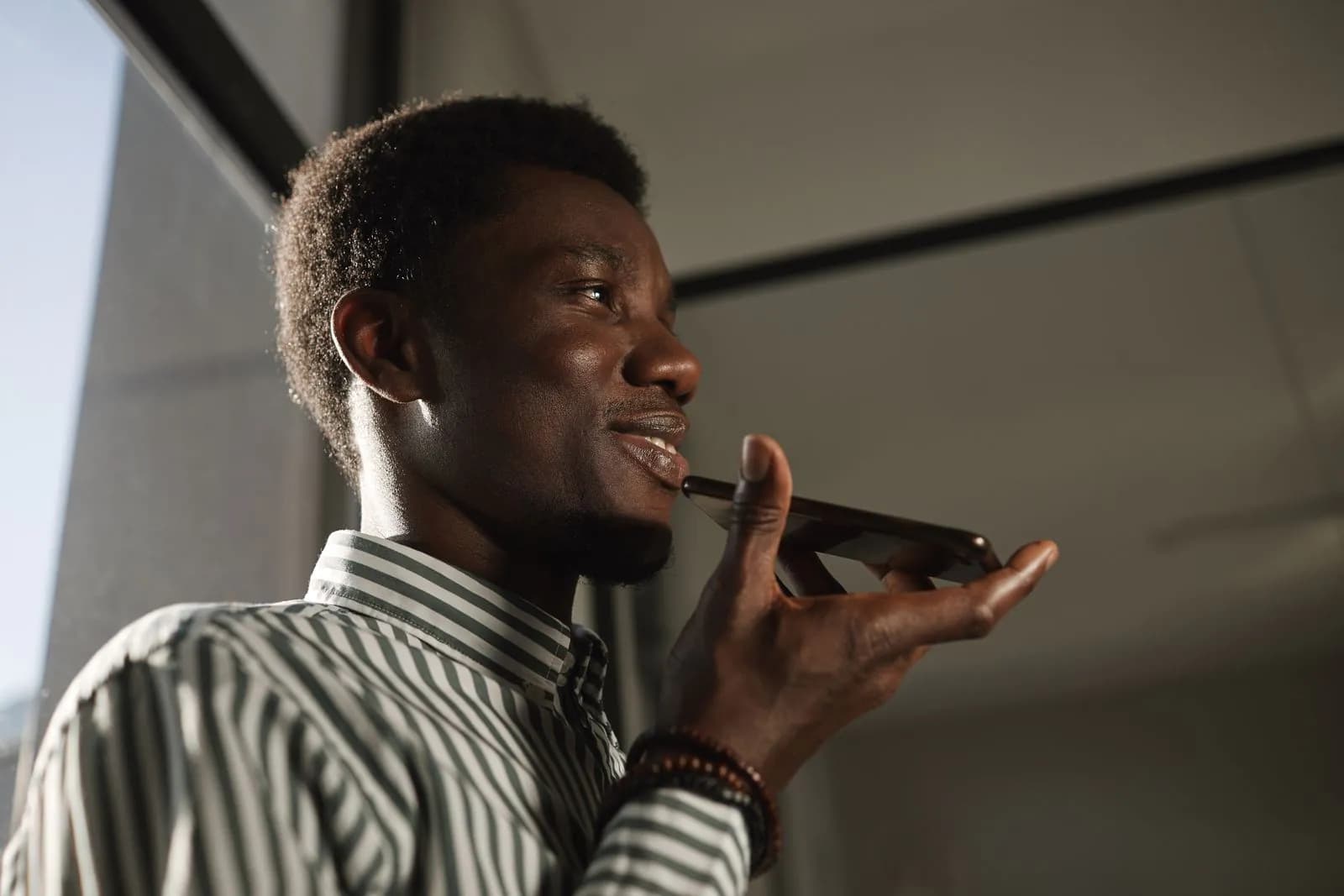 A man asking a voice assistant a question on his phone