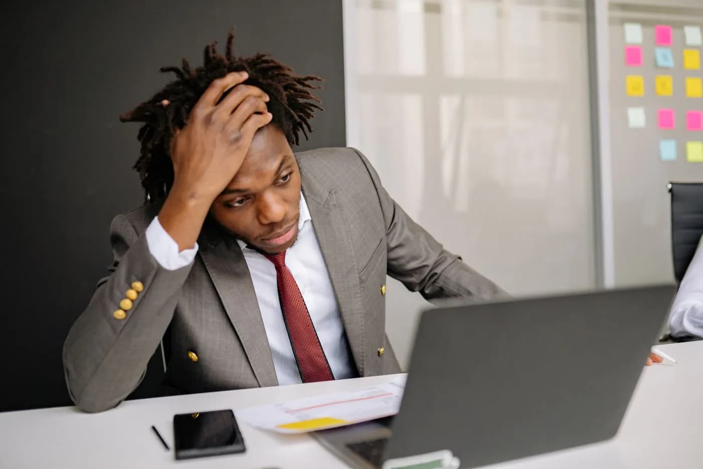 A worried businessman staring at his laptop
